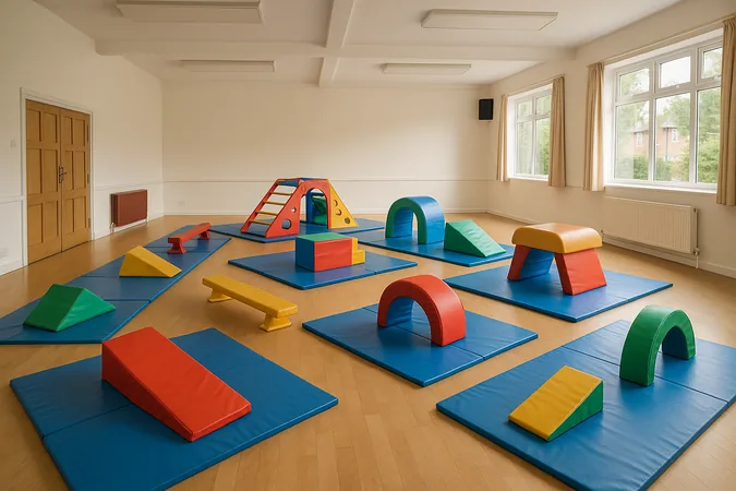 A preschool tumble tots gymnastics set-up in a community hall with soft foam wedges, low beams and a mini vault, preschool gymnastics classes in Surrey for babies, toddlers and parents